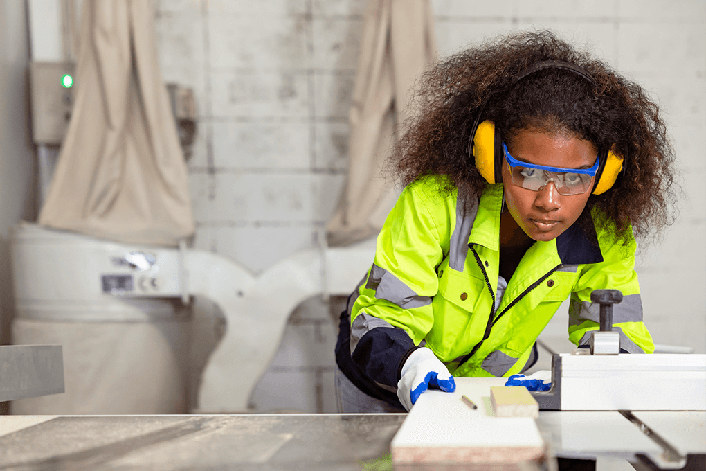 Female carpenter using electric sander