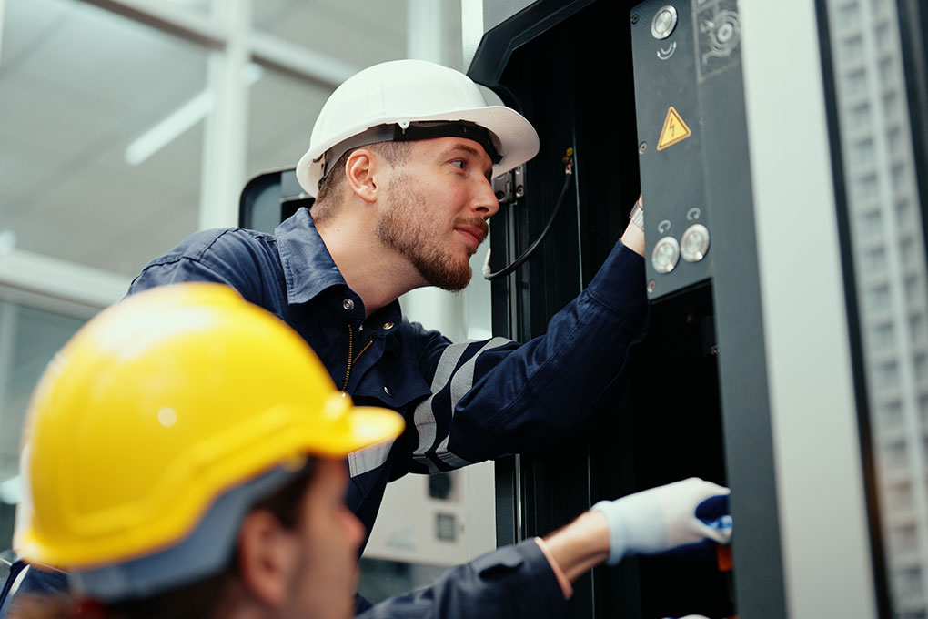 Electricians working on utility box