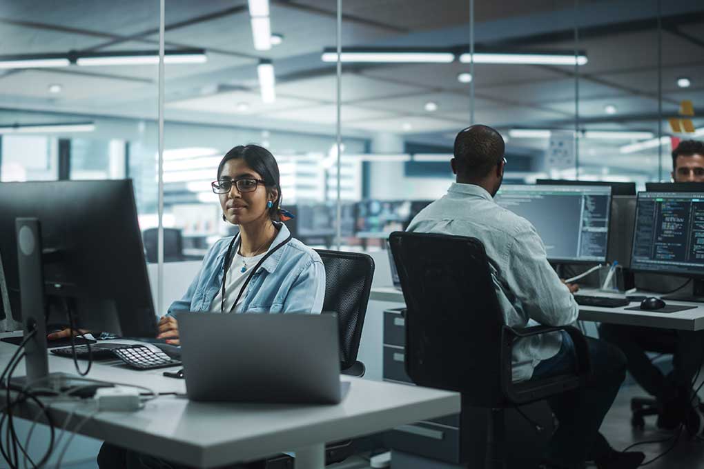 Programmer working on a desktop at work
