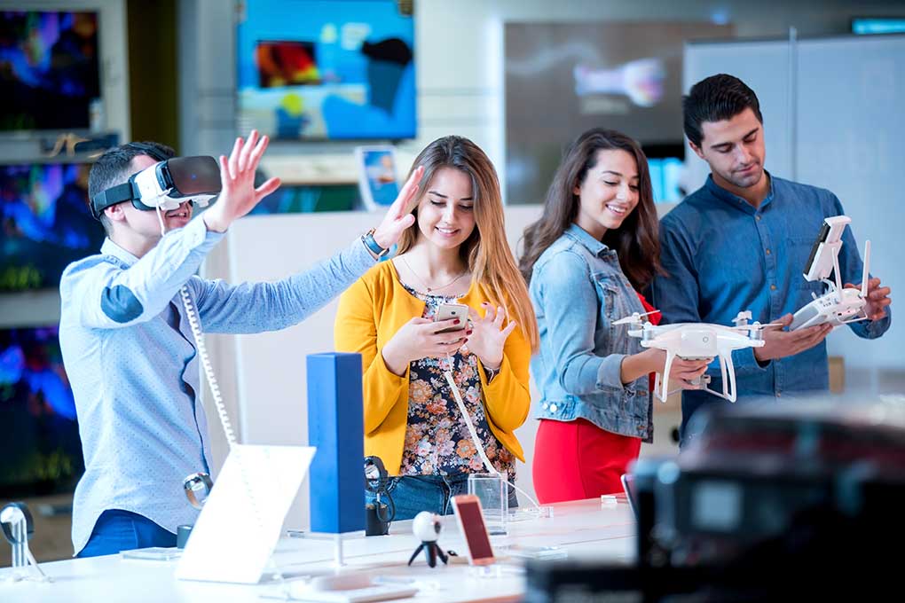 Group of people testing the latest electronics