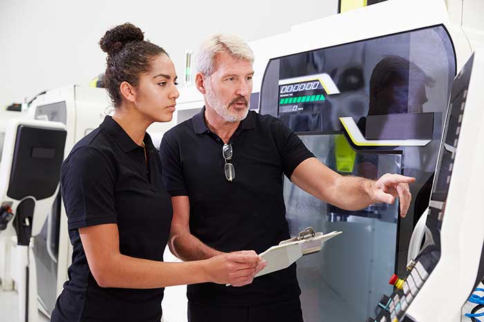 Employer reviewing work with employee